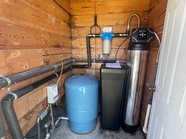 Water softener and filter installed in a well house in Boerne, Texas