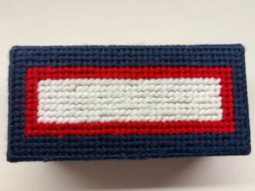 Handmade rectangular crochet piece with red, white, and blue colors.