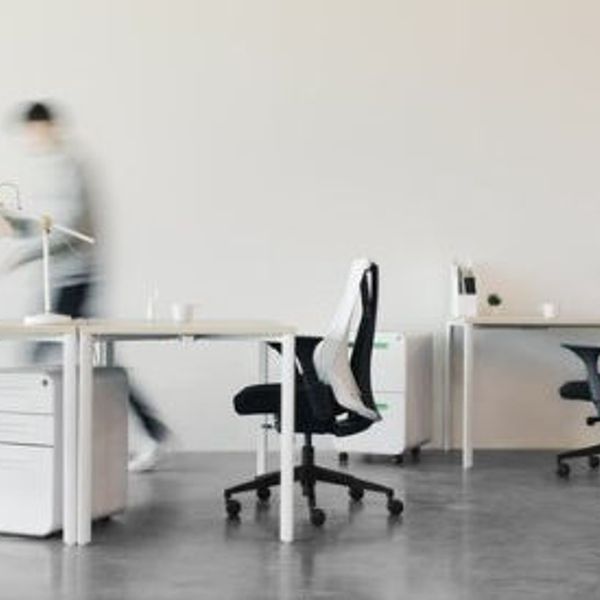 Empty office with one person walking.