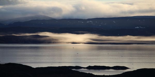fog forming over islands in Frobisher bay in early fall. Iqaluit, Nunavut
