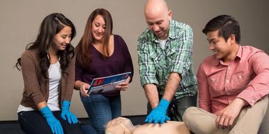 A group of people learning CPR