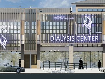 Modern dialysis center and clinic exterior with cars and silhouettes of people.