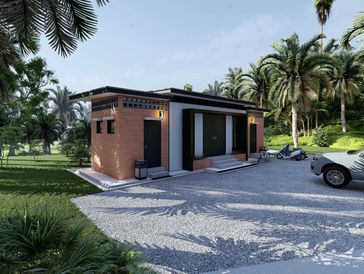 Modern brick building surrounded by palm trees with parked vehicles outside.