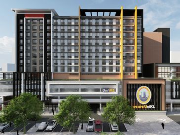 Modern multi-story building with UniKL signage and parked cars in front.
