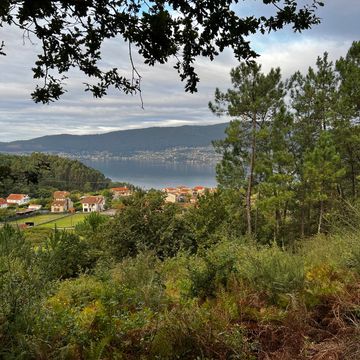 Camino de Santiago view of water and a small village. 