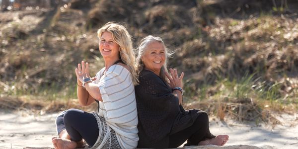 Laura Sumner and Sarah Daley of Camino Yoga Retreats seated outdoors.