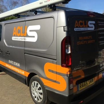 Silver trade van with orange and while vinyls.
