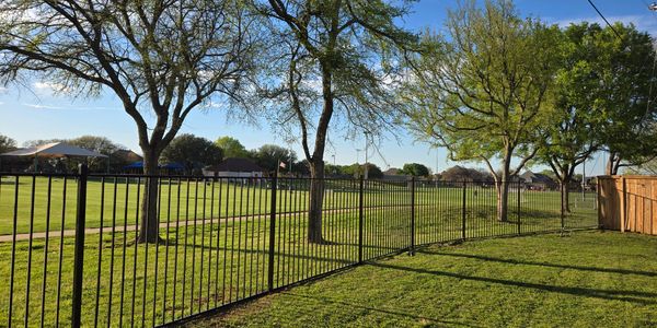 An elegant iron fence with intricate designs, adding a touch of sophistication to any property.