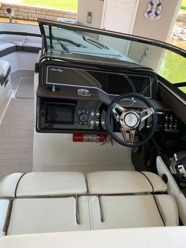 Mobile boat detailing service at dock with full setup in background