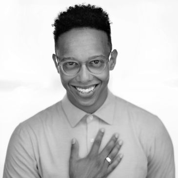 Black and white photo of Callum Francis. He is wearing Glasses and a shirt.