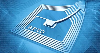 Close-up of an RFID chip with an upward arrow symbol on a blue background.