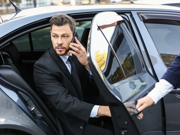 a businessman using a private driver