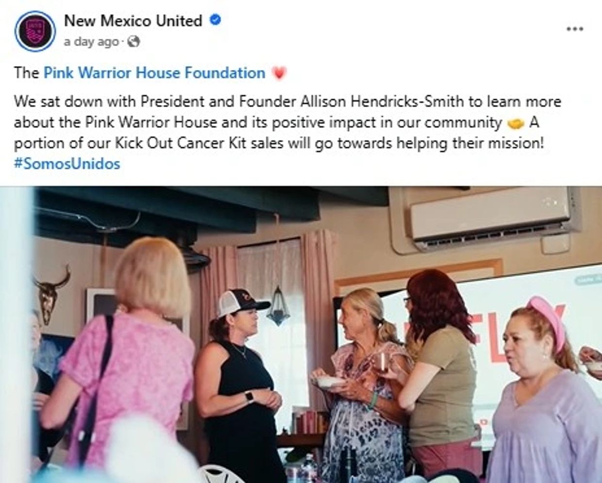 Group of women discussing the Pink Warrior House Foundation's impact in a community setting.
