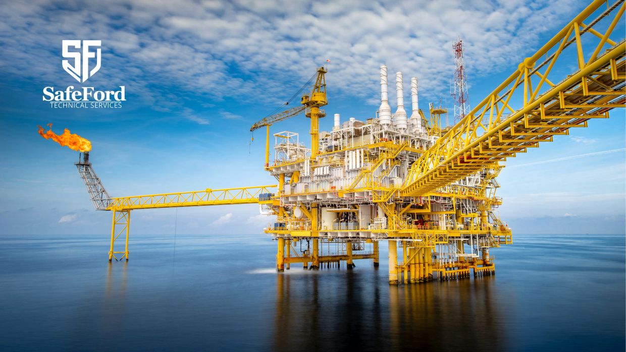 Yellow offshore oil rig with a gas flare under a cloudy sky.