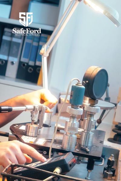 Technical equipment and hands operating a device at SafeFord Technical Services.