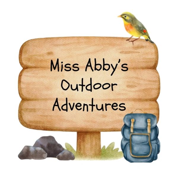 Wooden sign for Miss Abby's Outdoor Adventures with bird and backpack.