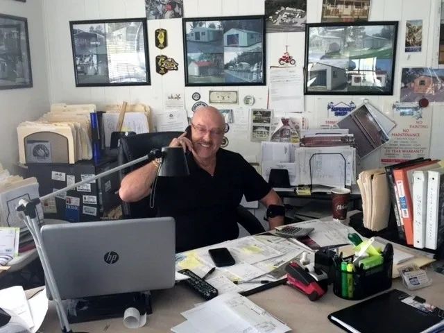 Bob sitting at his desk taking a phone call