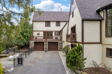 Large home with cream stucco exterior and double garage.