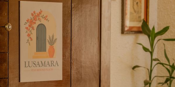 A decorative poster with floral design and text on a wooden wall.