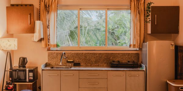 Cozy kitchen with large window and modern appliances.