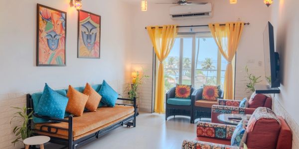 Bright living room with colorful cushions and yellow curtains.