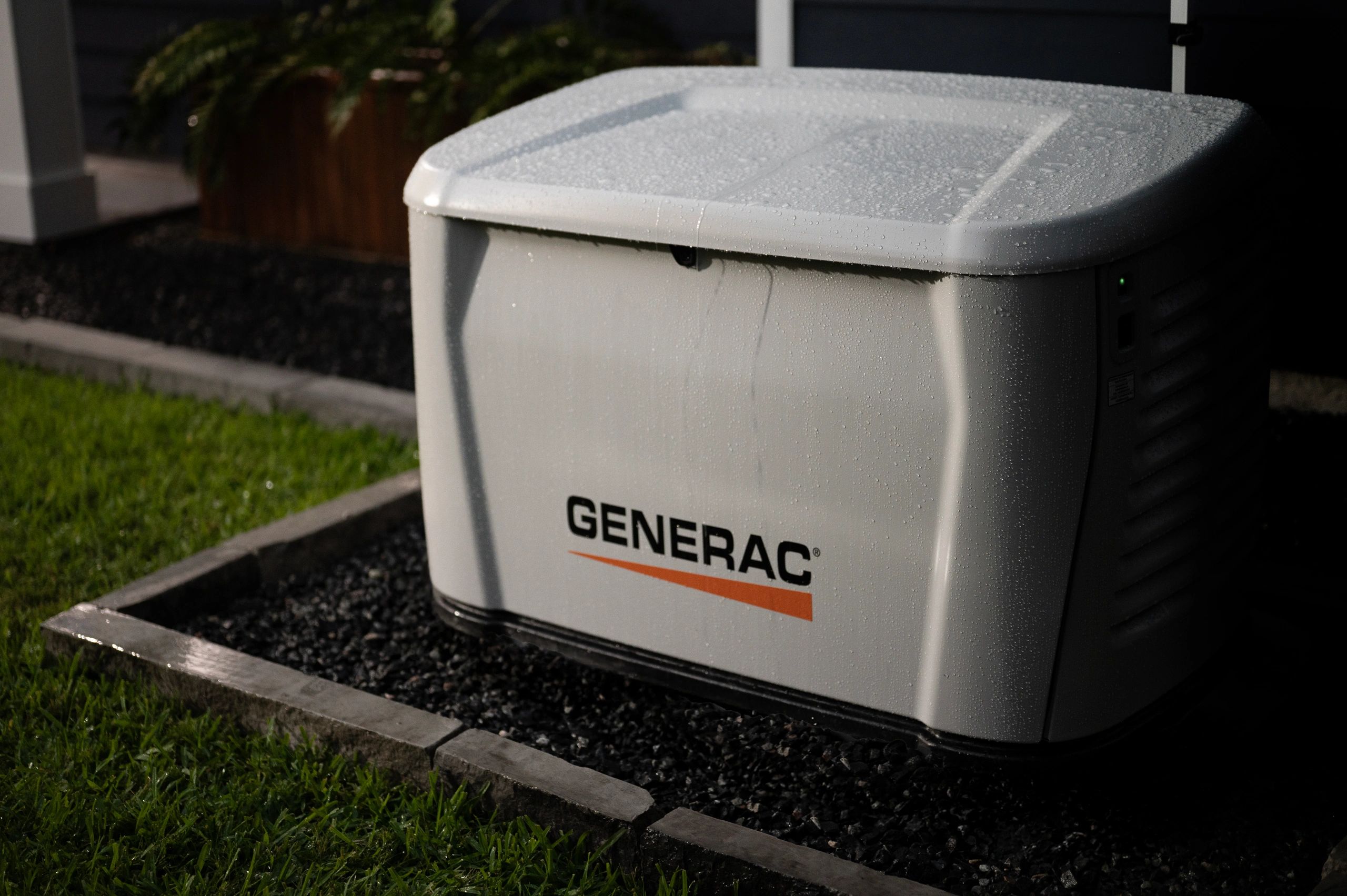 Generac home standby generator installed in a landscaped yard