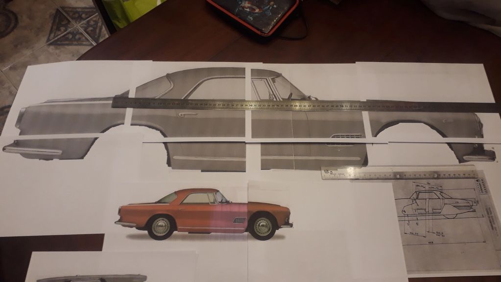 Blueprints and scale drawings of a classic car with measuring rulers.