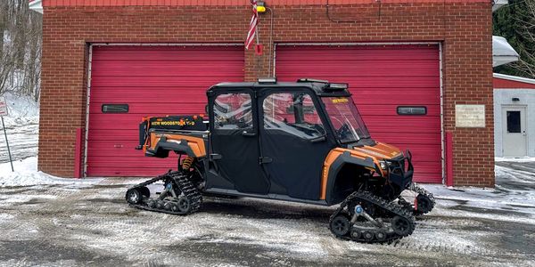 Four-wheeled snow vehicle with tank-like tracks.