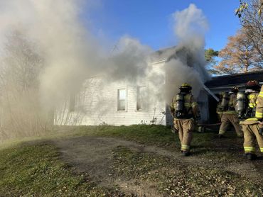 Firefighters respond to house fire with heavy smoke.