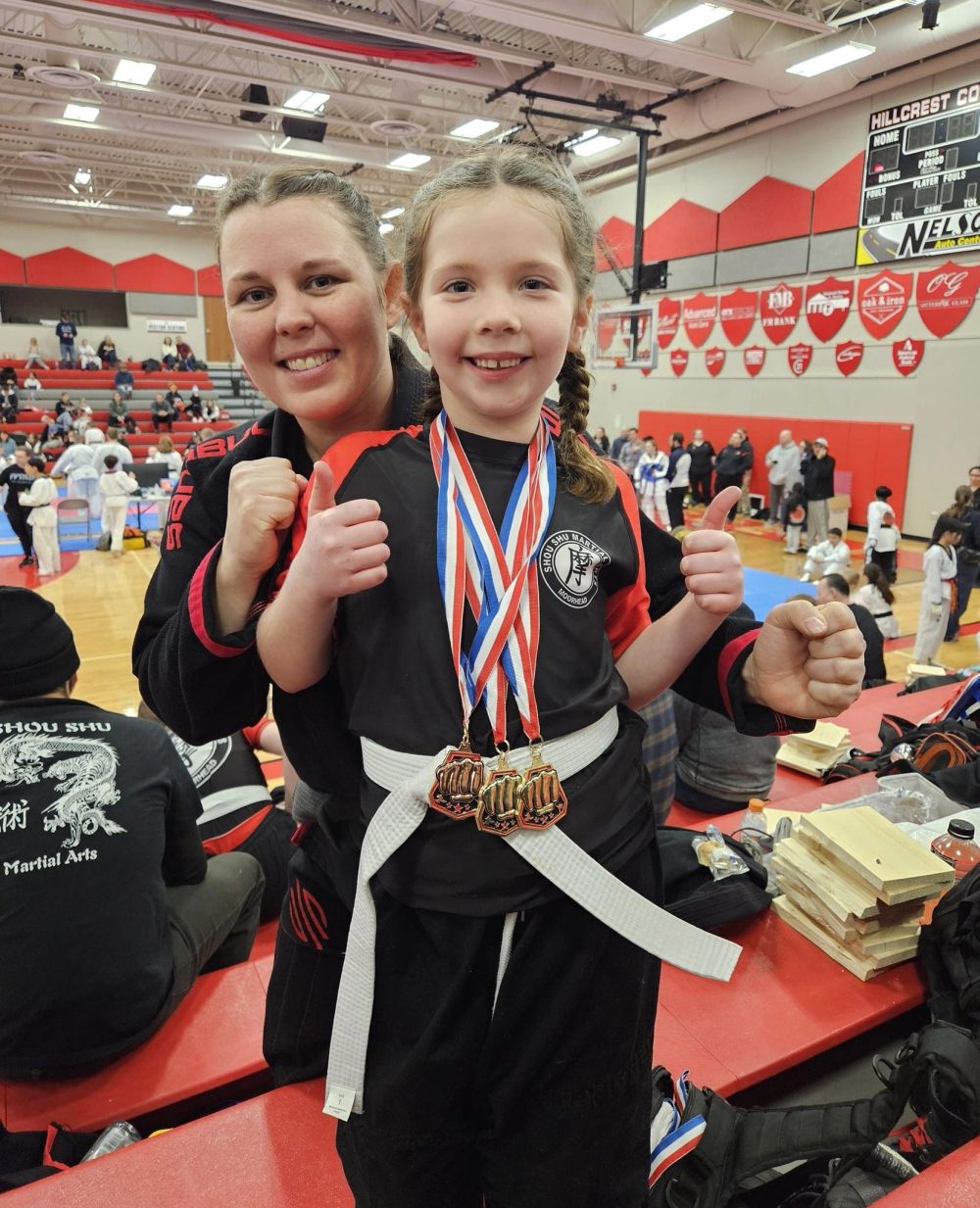 Shifu Alexis with a medal-winning young student