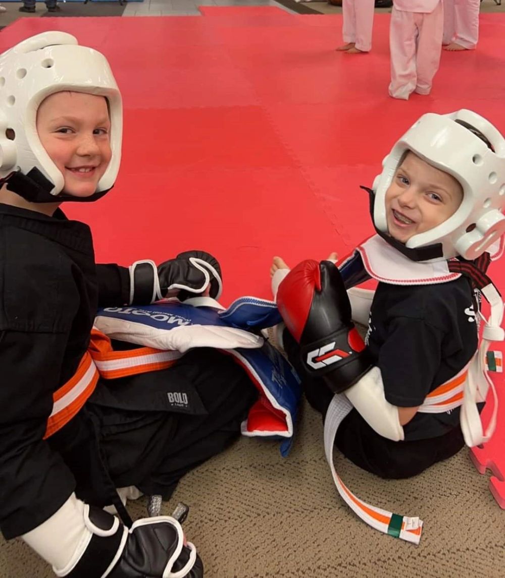 Two young Little Dragons students in sparring gear at the Moorhead studio