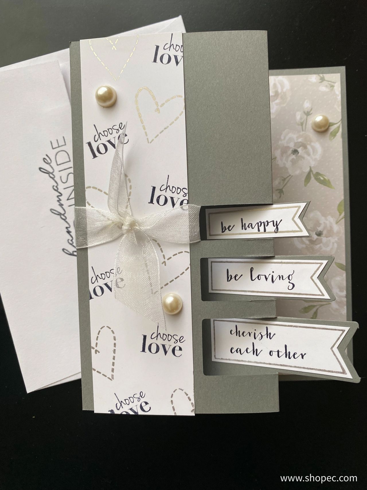 front of a triple flag card with an envelope behind it. 