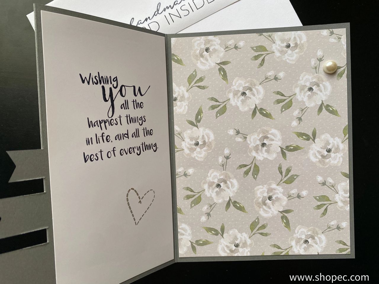 Triple flag card - inside. Right side has a gray floral pattern and left has a phrase “Wishing you all the happiest things in life, and all the best of everything.”