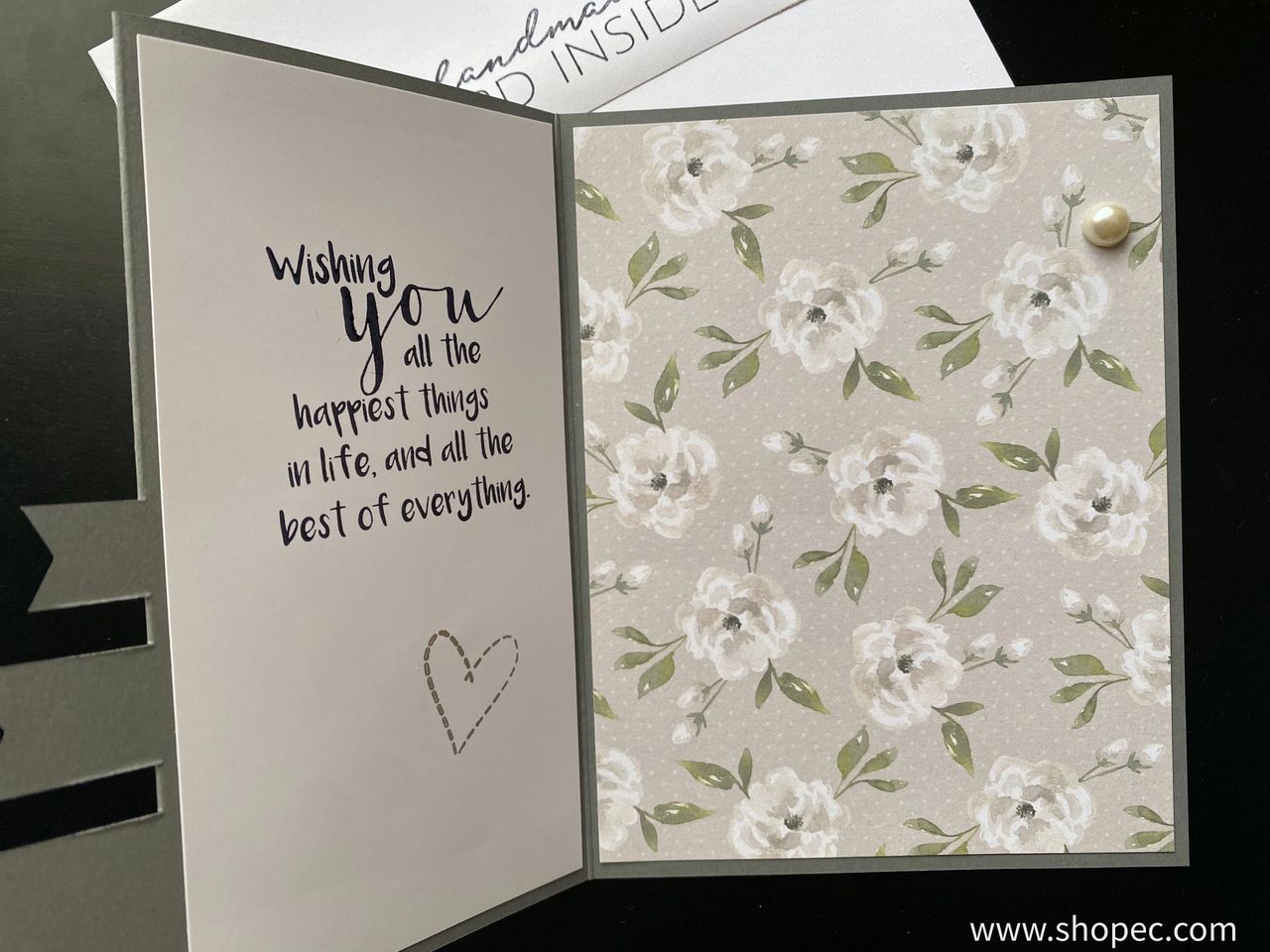 Triple flag card - inside. Right side has a gray floral pattern and left has a phrase “Wishing you all the happiest things in life, and all the best of everything.”