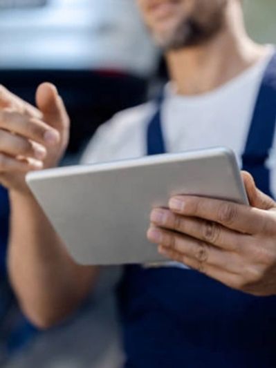 A man looking forward with a mobile phone in his hand