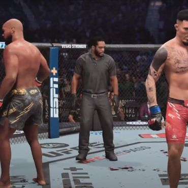 Two MMA fighters in a cage with a referee during a match.