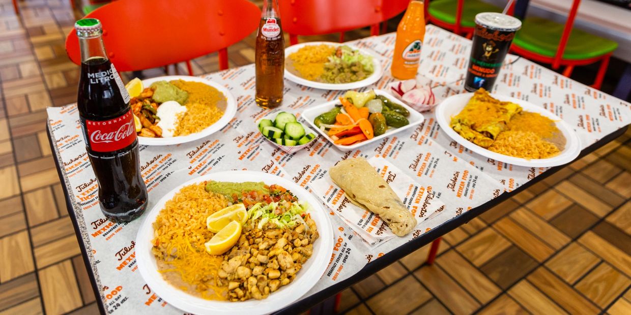 A table decorated with so many foods and drinks