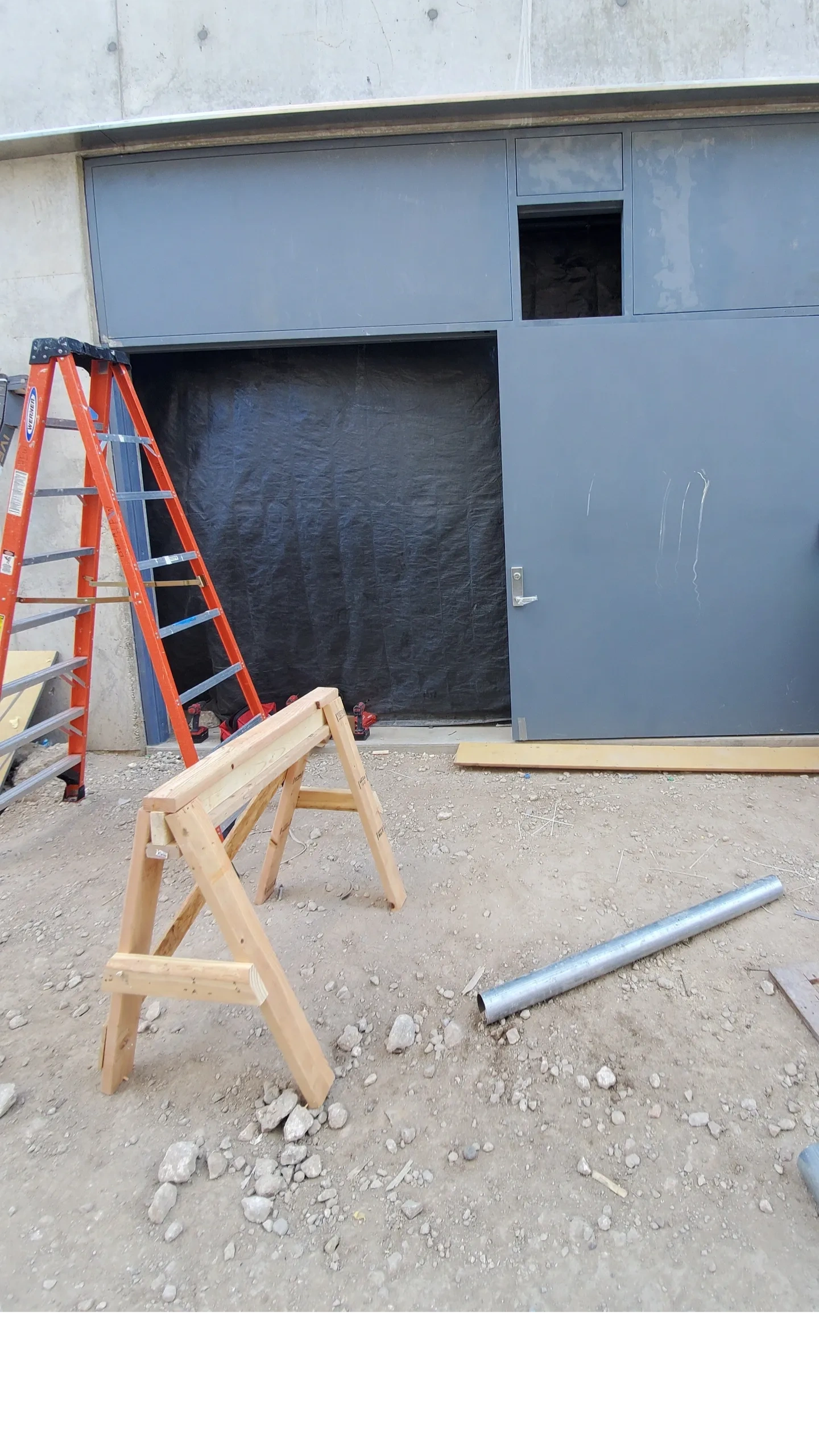 Construction site with door and ladder.