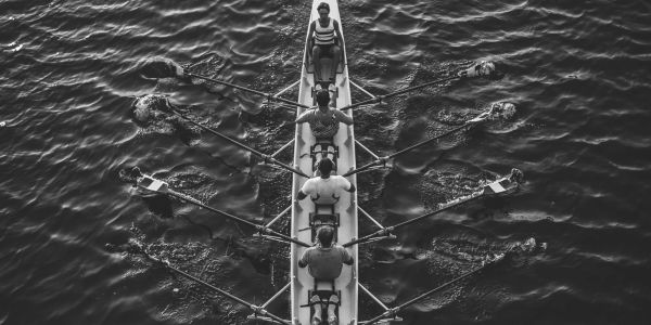 Racing row boat in choppy water.