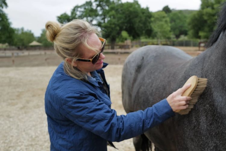 woman navigating loss and abuse in a horse-guided healing session
