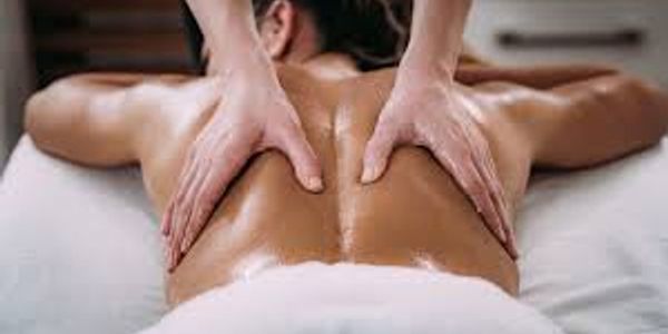 Person receiving a relaxing back massage with oil.