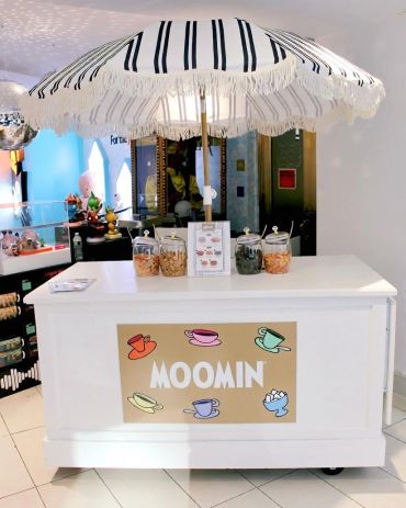 Moomin-themed snack stand with umbrella.