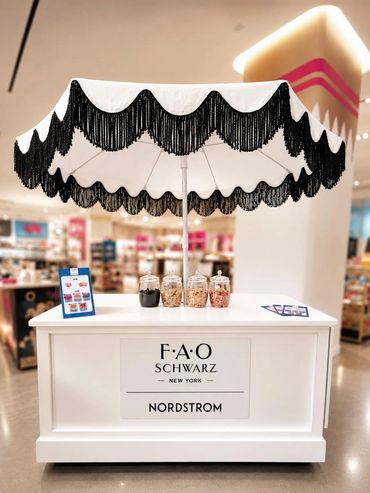 branded cart with black fringe umbrella for a brand activation in NYC