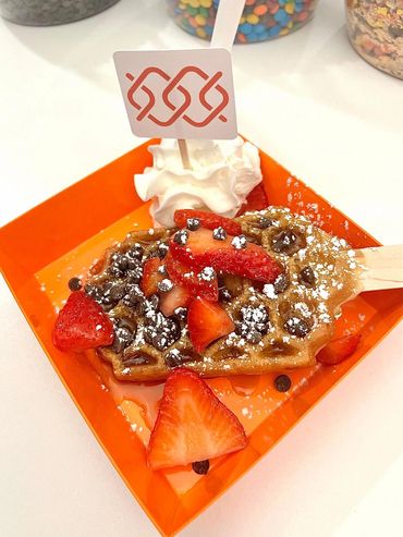 a waffle pop for a bank opening event that is in custom orange plating