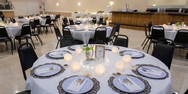 Elegant round dining table set with lights and tableware.