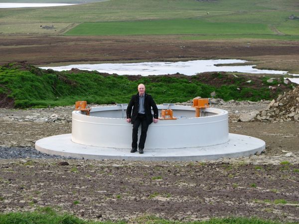 Mervyn Spence sitting on the foundation of the BHR Enercon E-70, 2009
