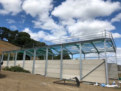 Farm shed steel frame with temporary fall prevention installed. safety netting and edge protection.