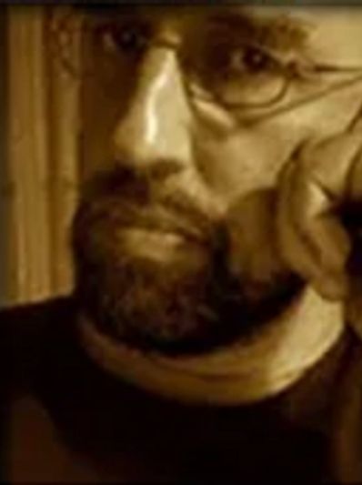 Sepia-toned close-up of a bearded man.