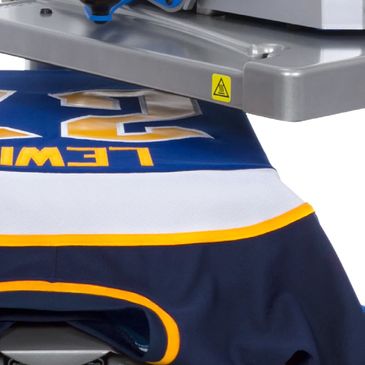 A freshly made hockey jersey on a Hotronix heat press.