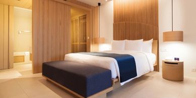 A modern hotel bedroom with soft lighting